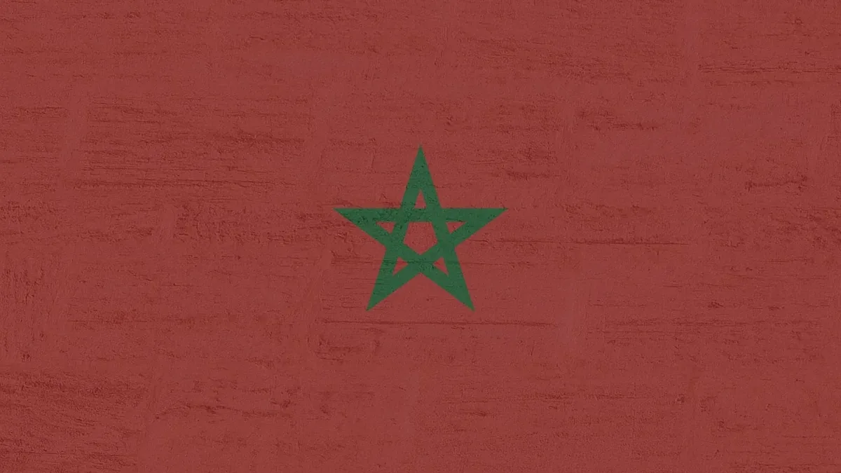 The flag of Morocco, featuring a green five-pointed star with a pentagram in the center.